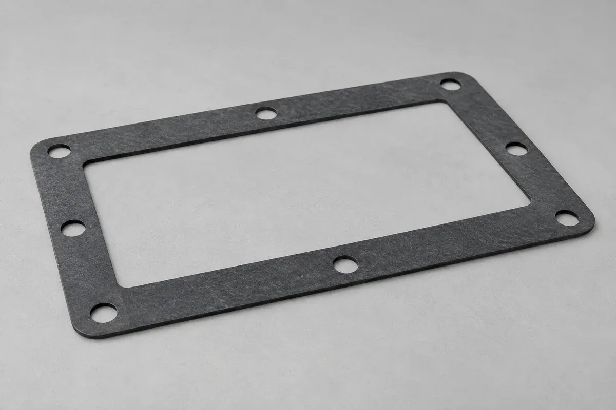 Flat rectangular gasket with bolt holes and a consistent sheet-like thickness