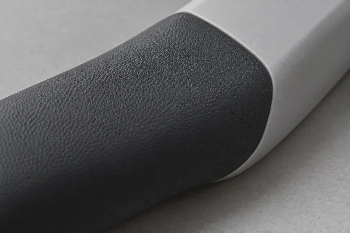 Illustrative close-up of an overmolded grip surface and its edge