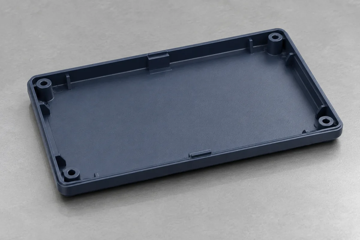 Unrestrained empty enclosure lid with slight illustrative corner lift on a flat support