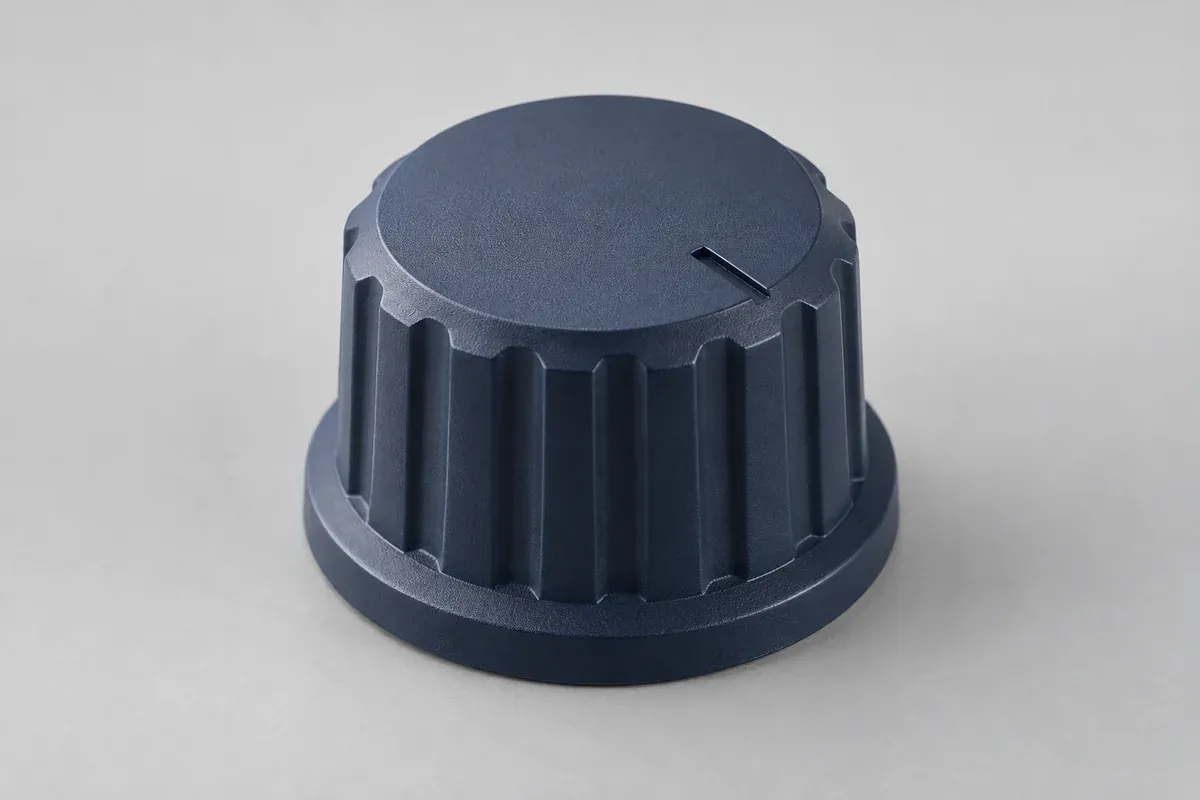 Navy plastic control knob with grip ribs and a molded index notch