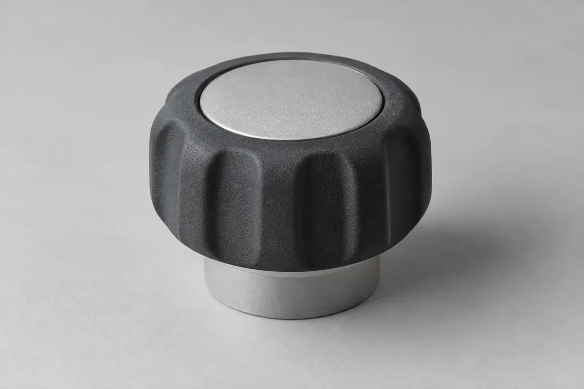 Plastic control knob with a contrasting compliant grip region